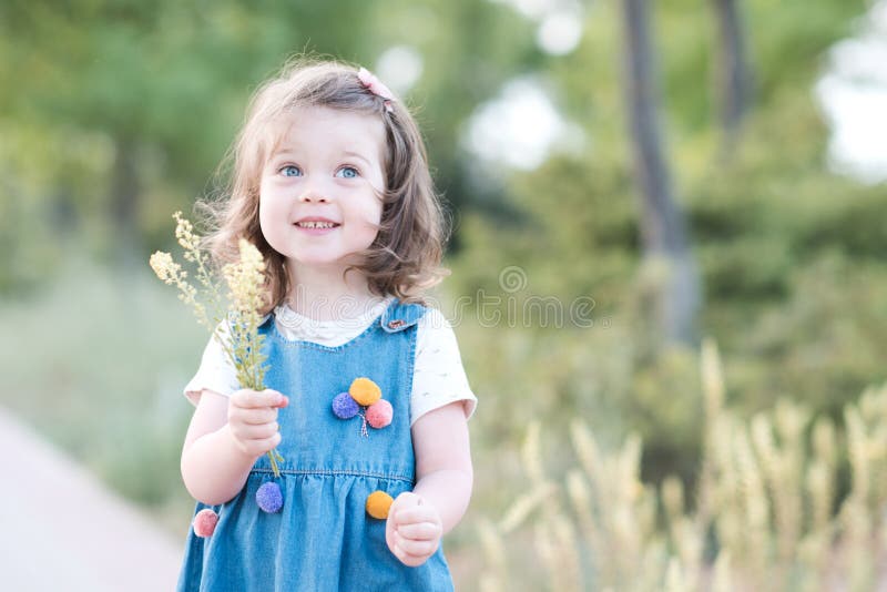 Cute kid girl 3-4 year old wearing stylish white dress and floral