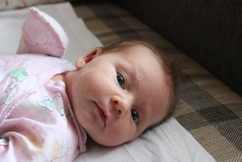 Cute Baby Lying on White Bed Sheet, Close Up Stock Photo Image of