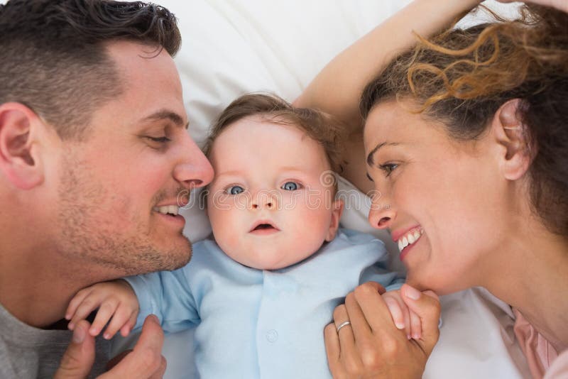 Cute Baby with Parents in Bed Stock Image Image of looking, caucasian