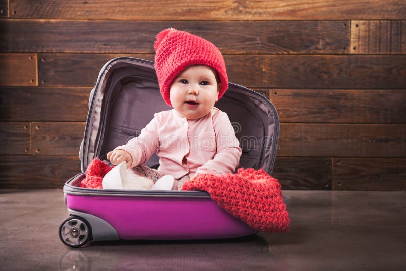 Cute baby in pink travel bag stock photo