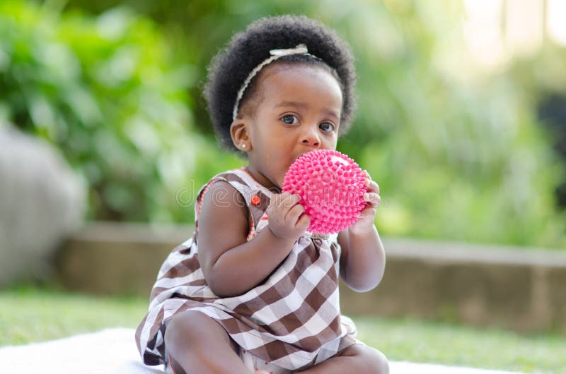 Cute Baby. Portrait of an African American baby playing outdoors with a ball stock photos