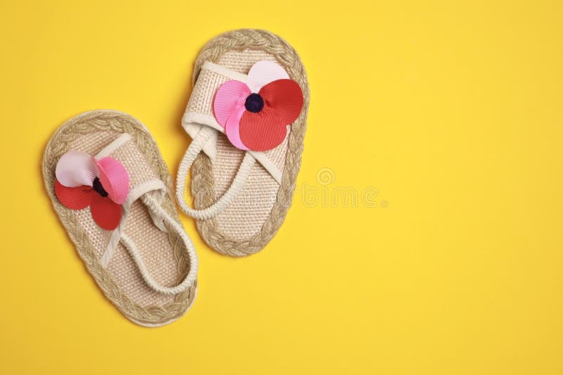 Cute Baby Shoes on Yellow Background, Flat Lay. Space for Text Stock