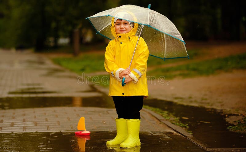 Cute Baby Standing Under an Umbrella on a Rainy Day. a Boy in a Yellow ...