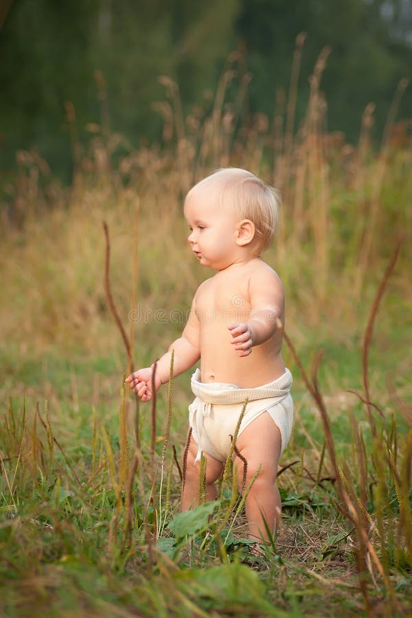 Cute baby walk in park on sunset