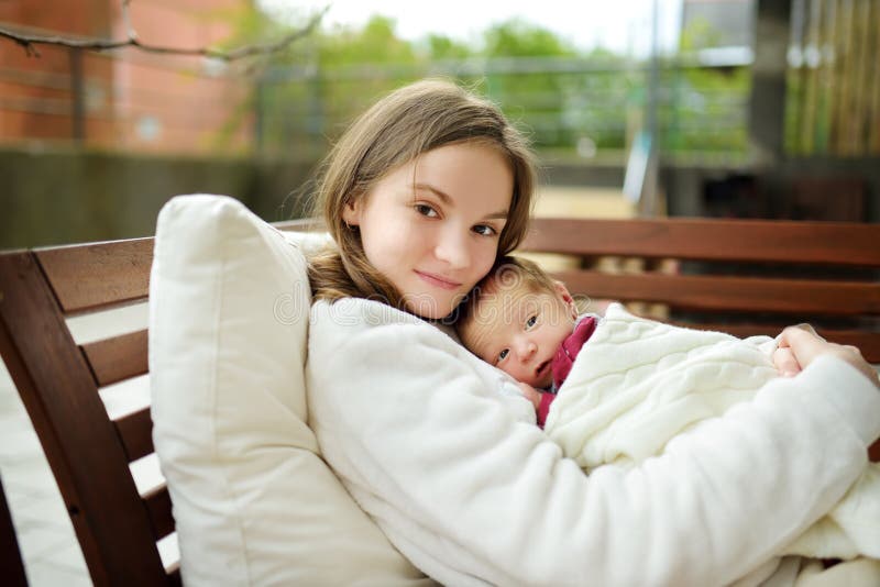 Cute Big Sister Admiring Her Newborn Brother. Adorable Teenage Girl Holding  Her New Baby Boy Brother. Kids With Large Age Gap Stock Image - Image Of  Admire, Blue: 186332131