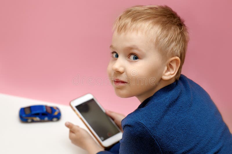 Cute Blond Baby Boy with Sly Smile Holding Mobile Phone in Hands and Making Video Shooting of Blue Car. Funny Face Expression of Y Stock Image - Image of funny, blogging: 181688613 Cute Blond Baby Boy with Sly Smile Holding Mobile Phone in Hands and Making Video Shooting of Blue Car. Funny Face Expression of Y Stock Image - Image of funny, blogging: 181688613
