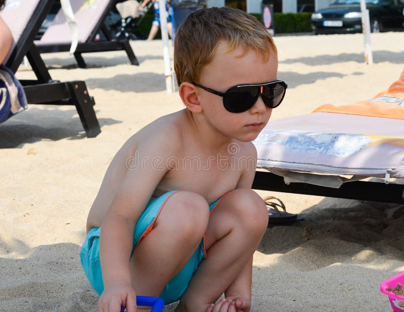 Cute blond serious child at the beach royalty free stock photography Cute blond serious child at the beach royalty free stock photography