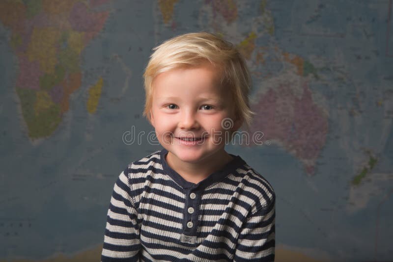 A Cute Blonde Child Smiles in Front of a World Map Stock Photo - Image of  background, climate: 154372264