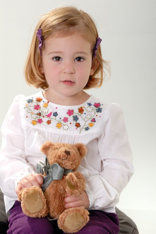 Cute blonde toddler with teddy