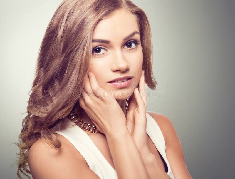 Cute blonde woman with brown eyes and long curly hairs