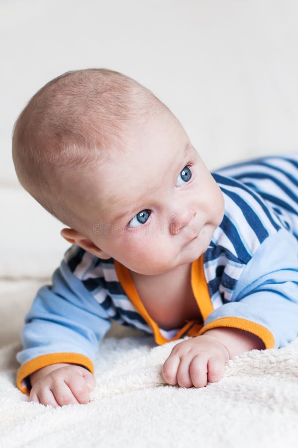 Cute blue-eyed baby boy looking to the right on a white background