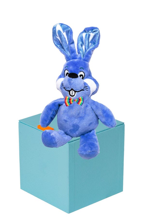Cute Blue Plush Bunny or Rabbit with Bow Tie on a Gift Box Isolated on