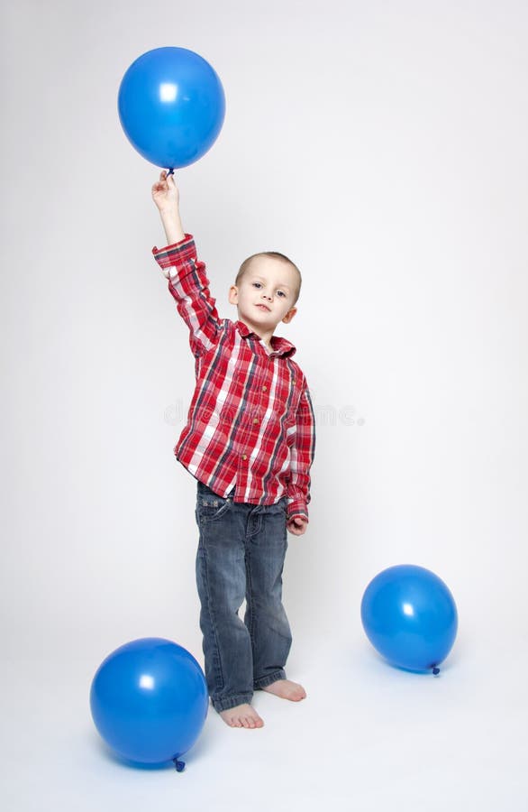 Cute boy with blue balloons