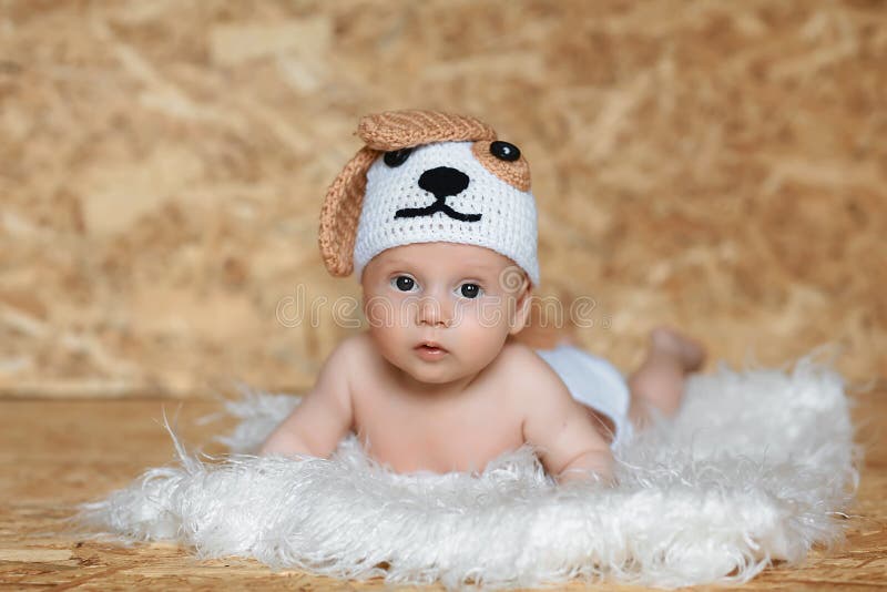Cute boy in a cap dog. Portrait of a 2 month old baby royalty free stock photos Cute boy in a cap dog. Portrait of a 2 month old baby royalty free stock photos