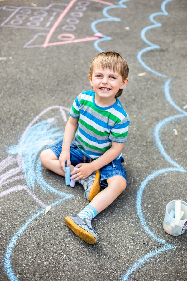 Cute Boy and Girl Drawing with Chalk on the Sidewalk in the Park. Stock ...