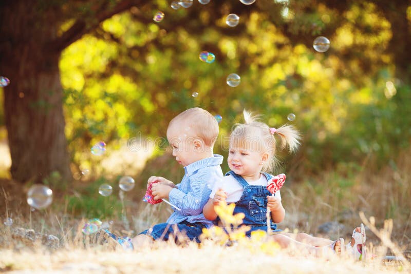 Cute boy and girl playing together summer outdoors