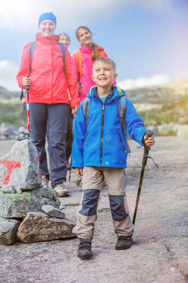 Best Norway hike. Cute girl with hiking equipment in the mountains