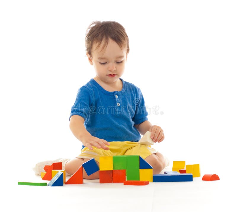 Cute boy is playing with colorful building blocks stock photos