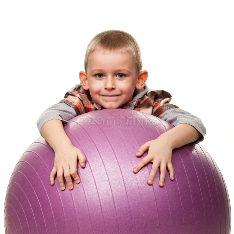 Cute boy playing with fit ball