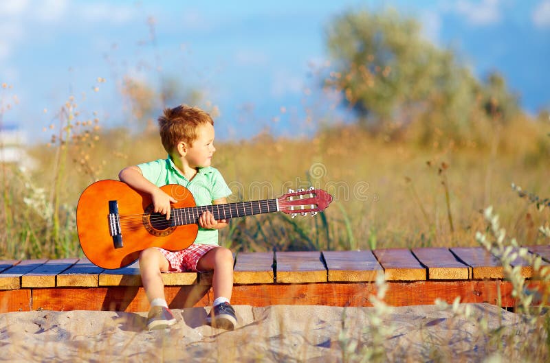 cute boy playing guitar