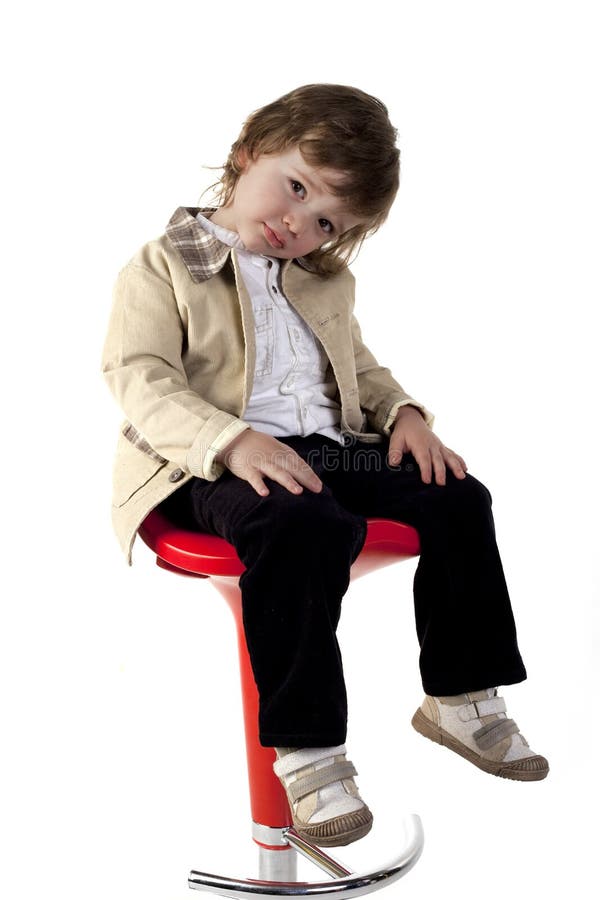 Cute boy sitting on a chair