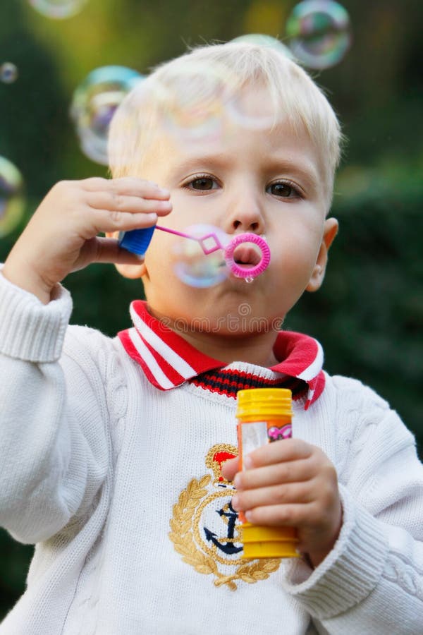 Cute boy with soap bubbles