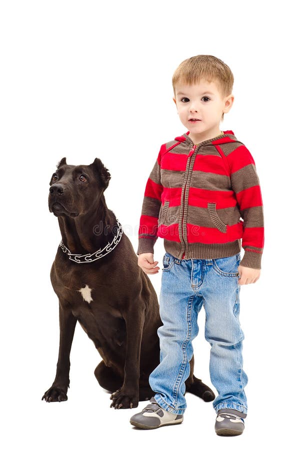 Cute boy standing next to a dog