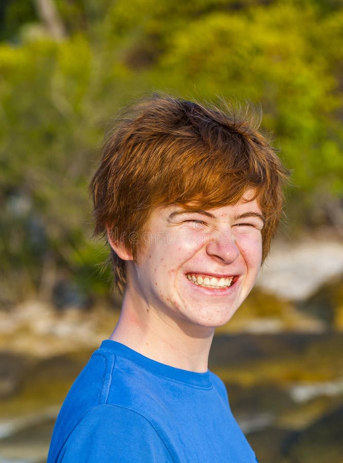 Cute boy at the tropical beach with funny face