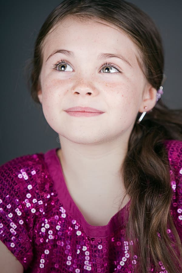 Cute Brown Haired Girl Looking Up Off Camera royalty free stock images