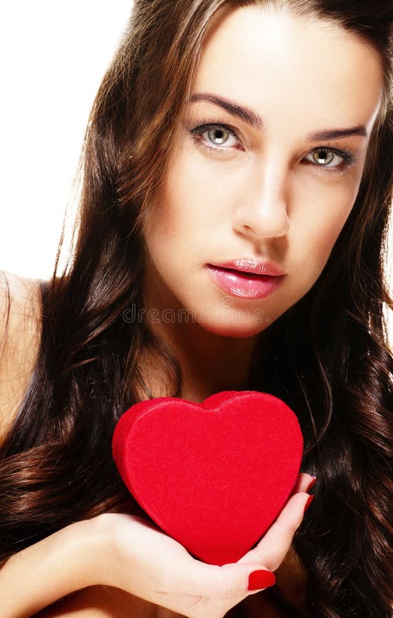 Cute brunette woman holding red heart