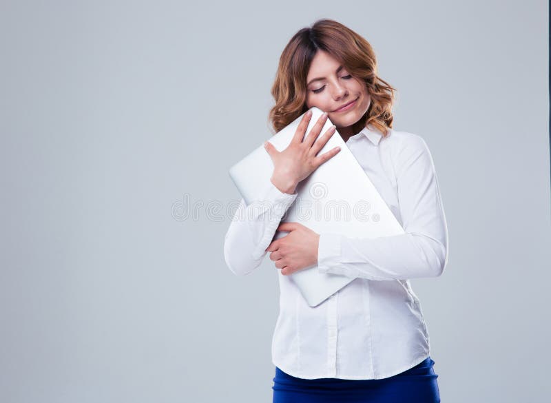 Cute businesswoman hugging laptop royalty free stock images