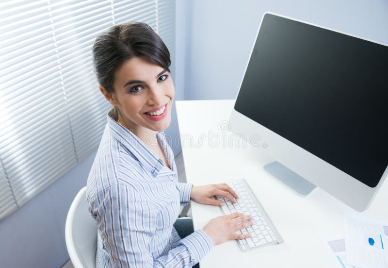 Cute businesswoman smiling at desk stock photo