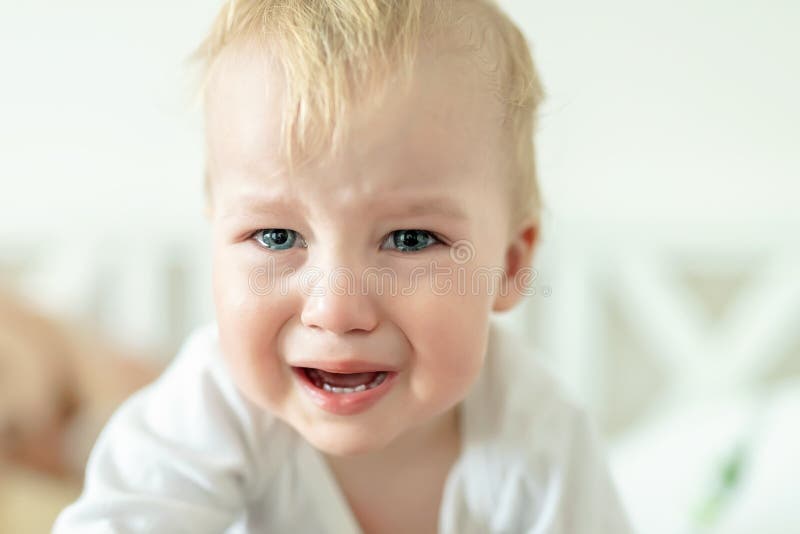 Cute caucasian blond toddler boy portrait crying at home during hysterics. Little child feeling sad. Little actor acting sadness royalty free stock images Cute caucasian blond toddler boy portrait crying at home during hysterics. Little child feeling sad. Little actor acting sadness royalty free stock images