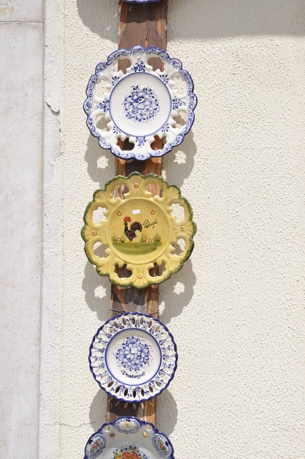 Traditional ceramic Souvenirs on the wall of a Souvenirs shop in Downtown of Alcobaca in Portugal