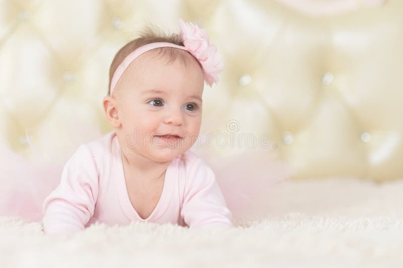 Portrait of cute charming girl in pink dress