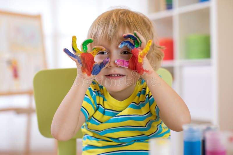 Cute cheerful kid with hands painted in bright colors royalty free stock image Cute cheerful kid with hands painted in bright colors royalty free stock image