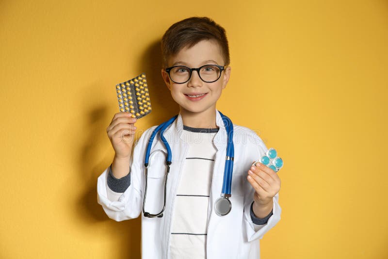 Cute Child In Doctor Coat With Pills Stock Image - Image of medicine, patient: 140209561