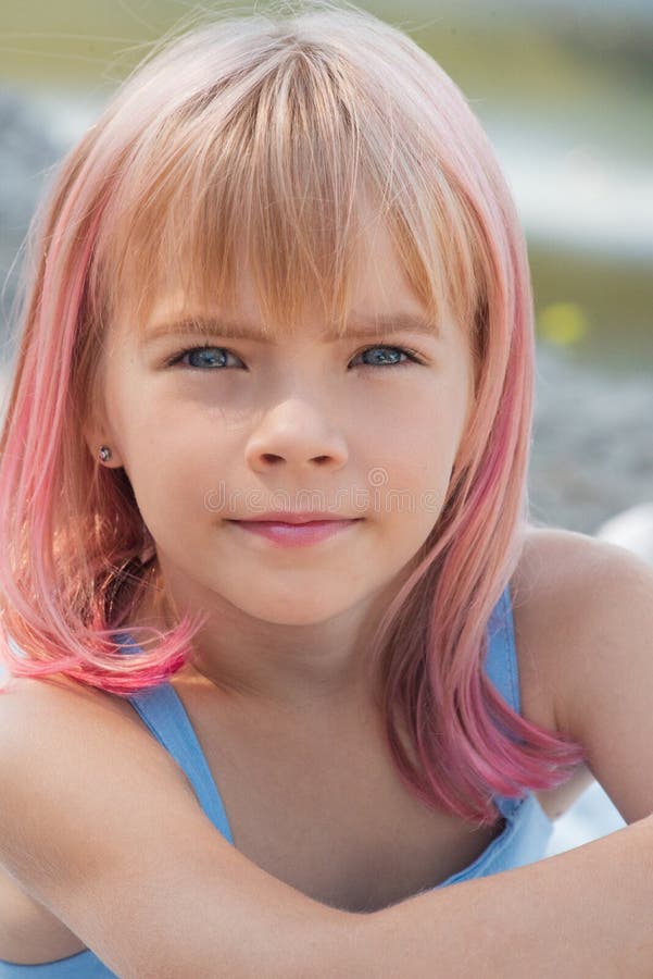 Cute child girl portrait . Outdoor portrait of cute little girl in summer day. Portrait of a little girl with pink hair