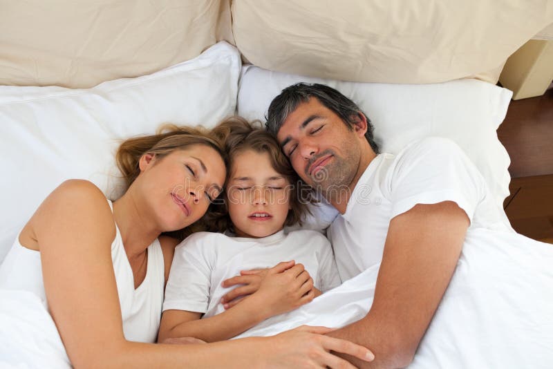 Cute Child And His Parents Sleeping Together Royalty Free Stock