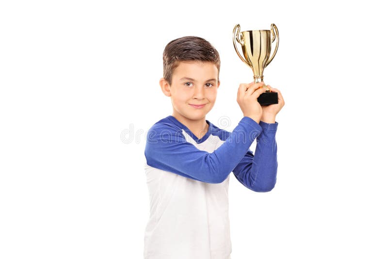 Cute child holding a golden trophy stock photo Cute child holding a golden trophy stock photo