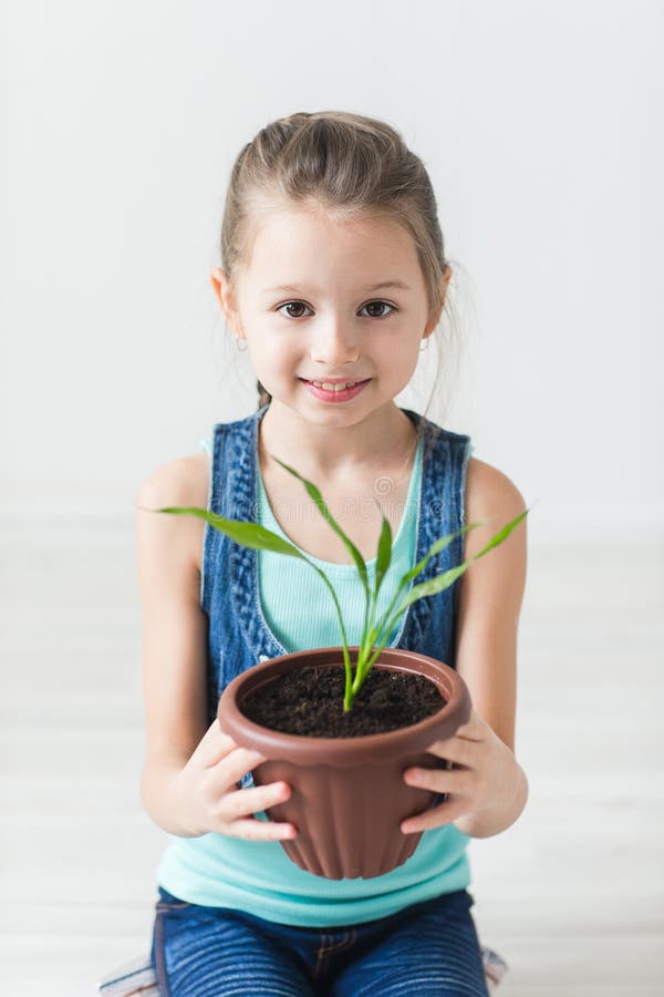 Cute Child Holding a Potted Plant Stock Image - Image of conservation