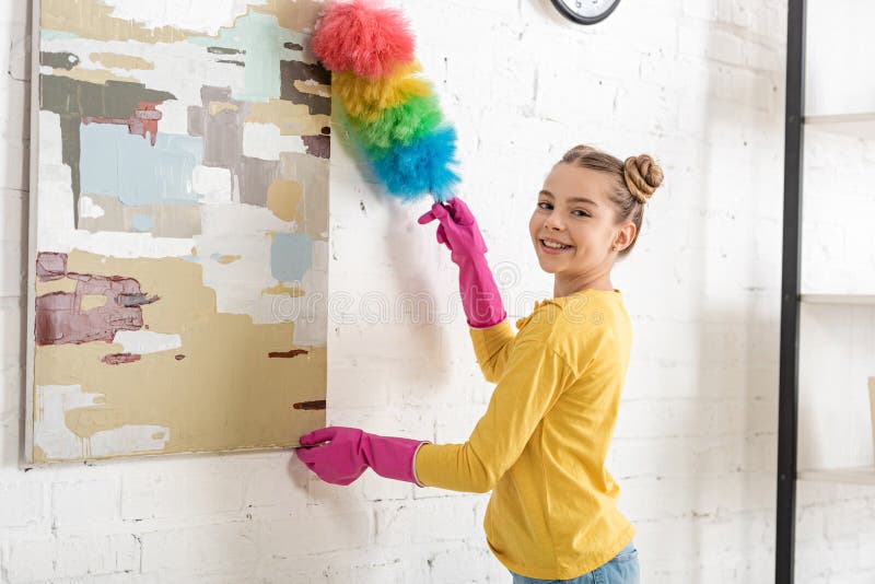 Cute child in rubber gloves sweeping