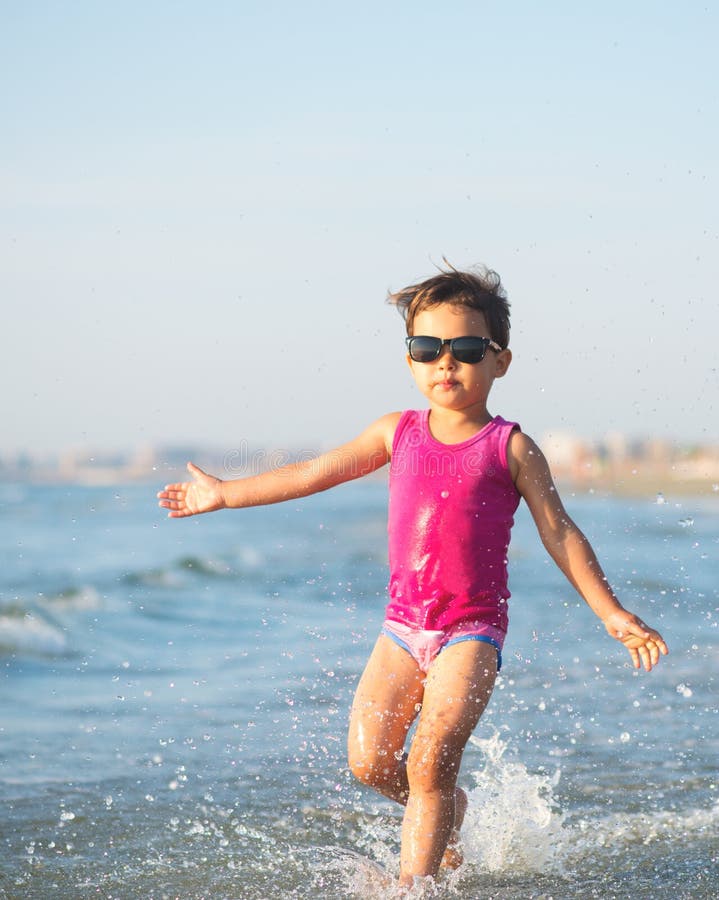 Cute Child Running in the Waves at Seaside Stock Photo - Image of ...