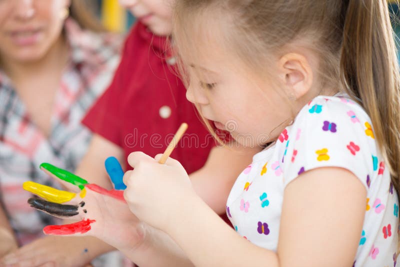 Cute children painting at kindergarten stock photography