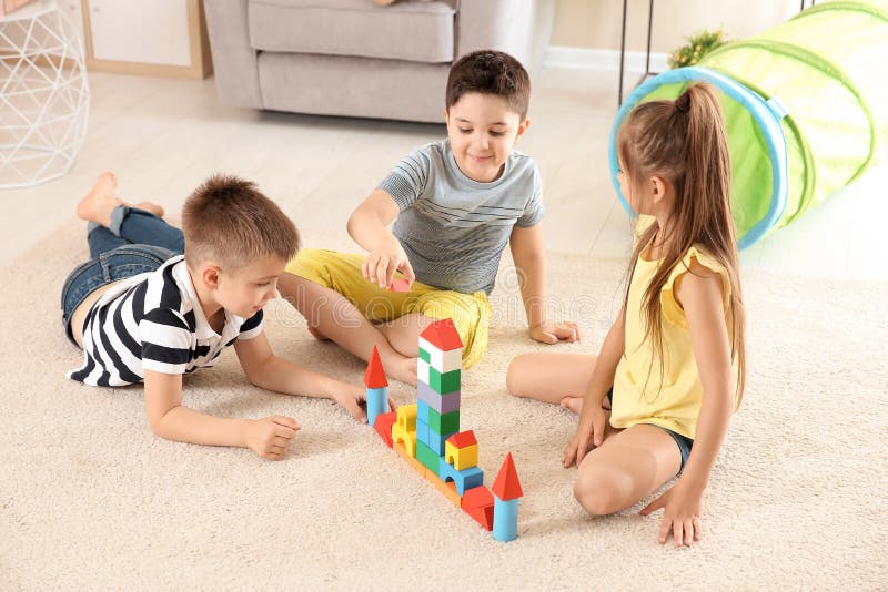 Cute Children Playing With Building Blocks On Floor Indoors Stock