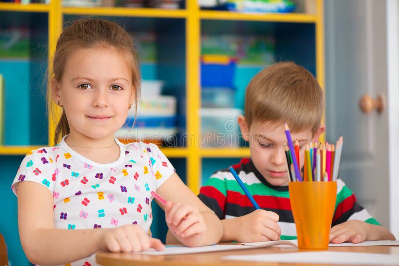 Cute children study at daycare stock photos