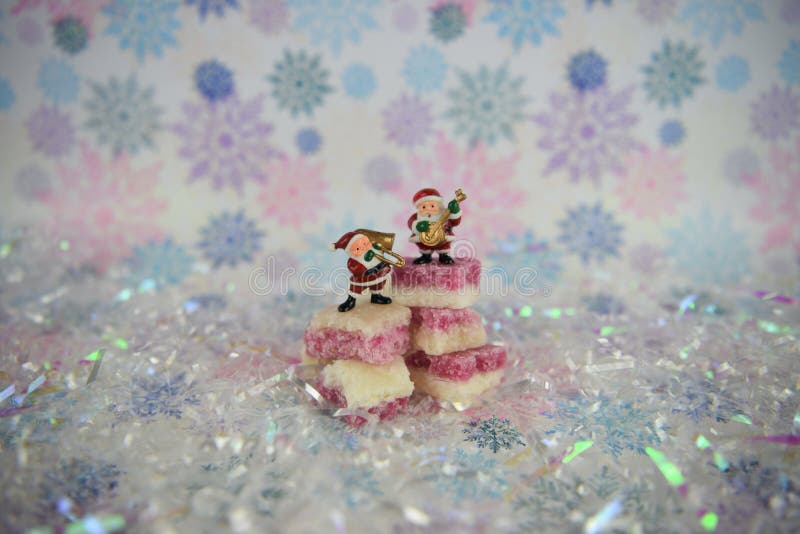 Cute Christmas food photography picture with old fashioned English coconut ice sweets with Santa Claus music playing decorations stock images Cute Christmas food photography picture with old fashioned English coconut ice sweets with Santa Claus music playing decorations stock images