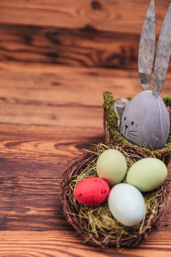 Cute Concrete Eggrabbit Figure Near Easter Egg Basket Stock Image