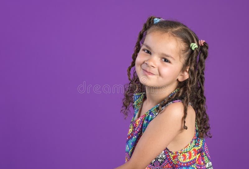 Cute Curly Haired Little Girl With Impish Smile Stock Image