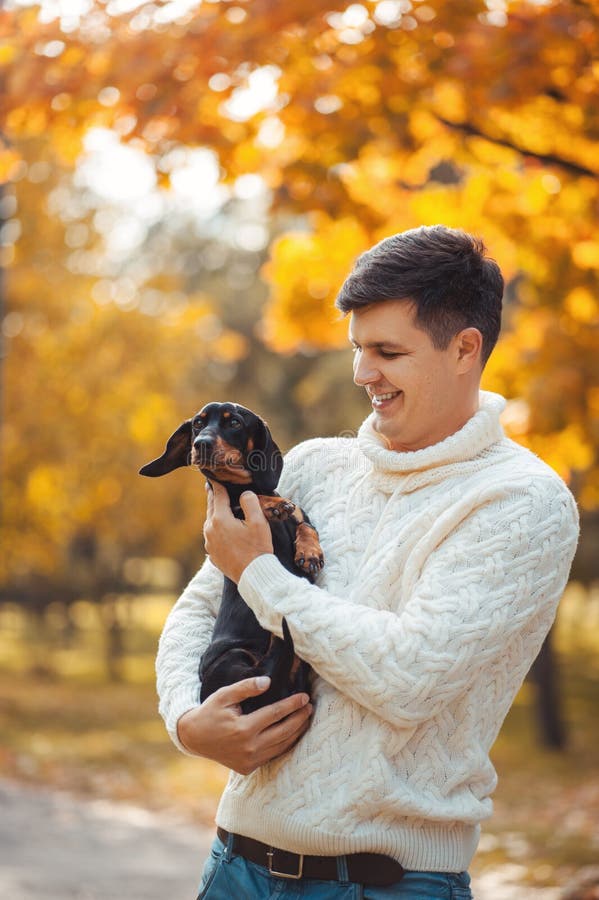 Cute dog and his owner have fun in the park royalty free stock images Cute dog and his owner have fun in the park royalty free stock images